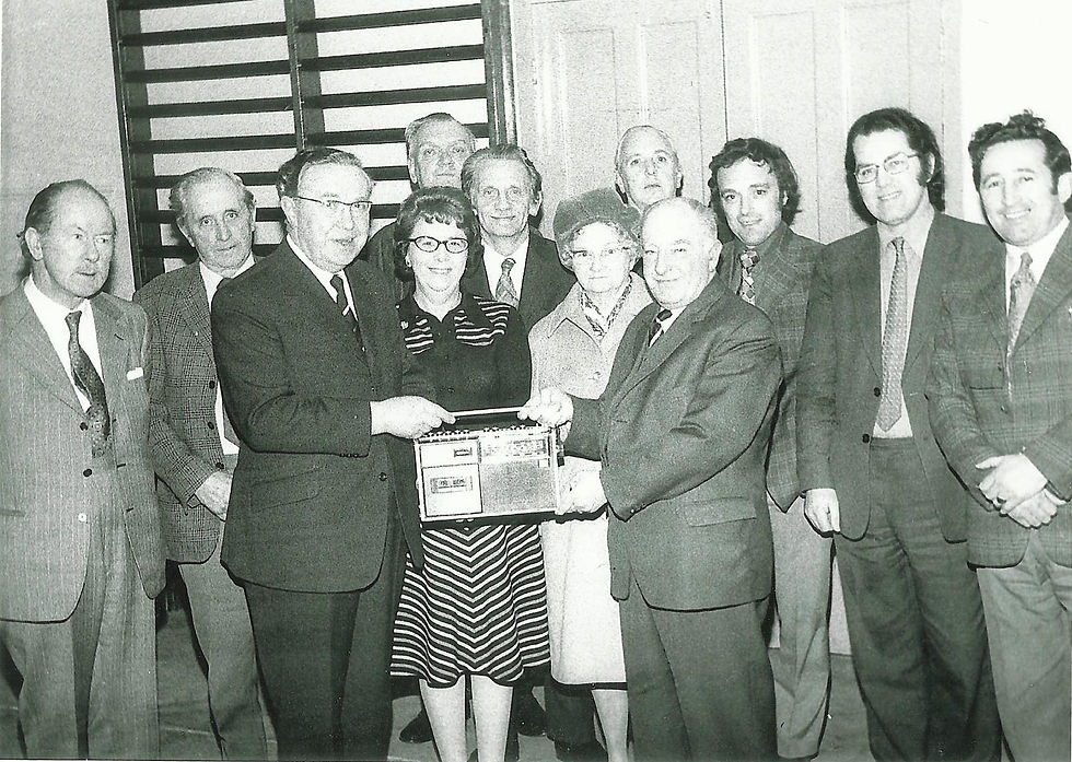1975 Emlyn Davies(retiring Treasurer) presented with gift by Islwyn Jenkins