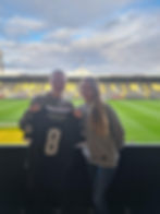 Young female footballer holding football shirt