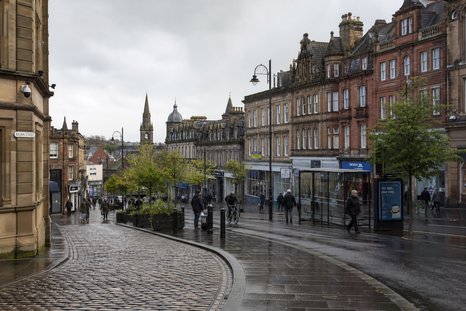 Rainy street scene with historic buildings, cobblestones, and pedestrians under a cloudy sky.