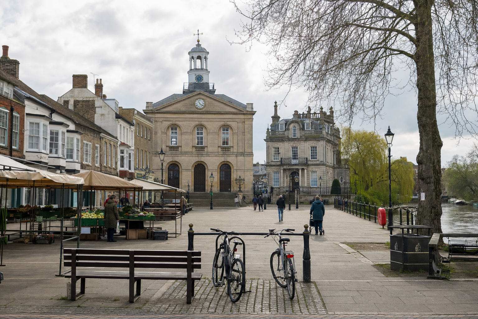 Two bicycles parked near a historic market square with a town hall and people walking nearby.