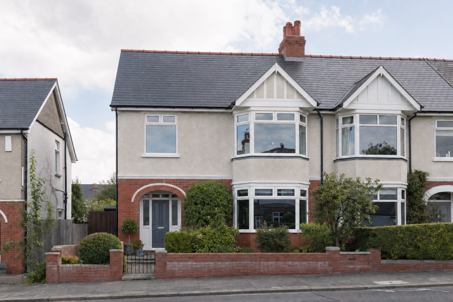 Semi-detached house with a brick façade, bay windows, and a small front garden on a suburban street.