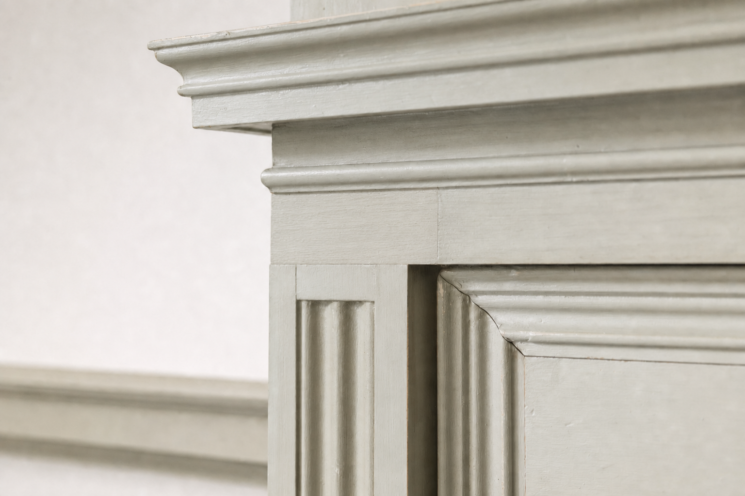 Close-up of elegant grey moulding detail on a wall or furniture piece.