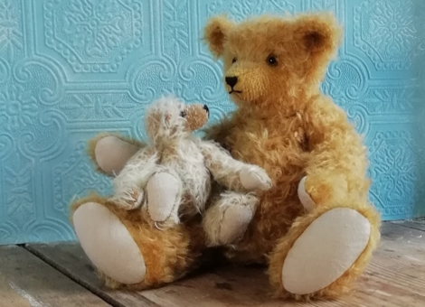 little bear sitting on big bear's knee