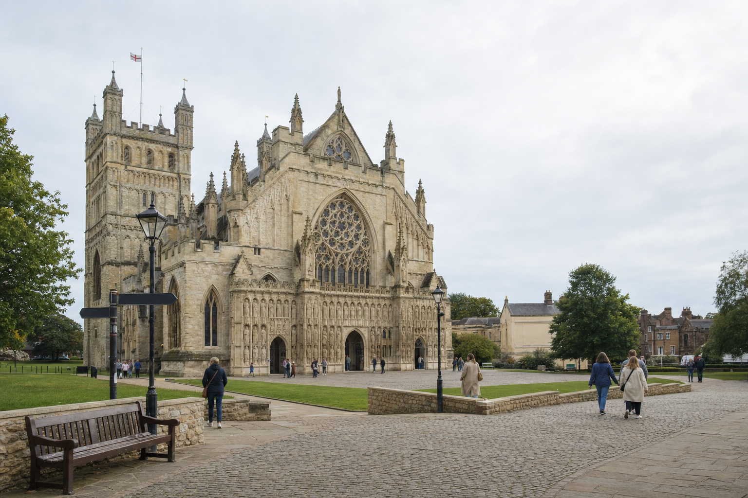 Exeter Cathedral with people walking around the courtyard on an overcast day.