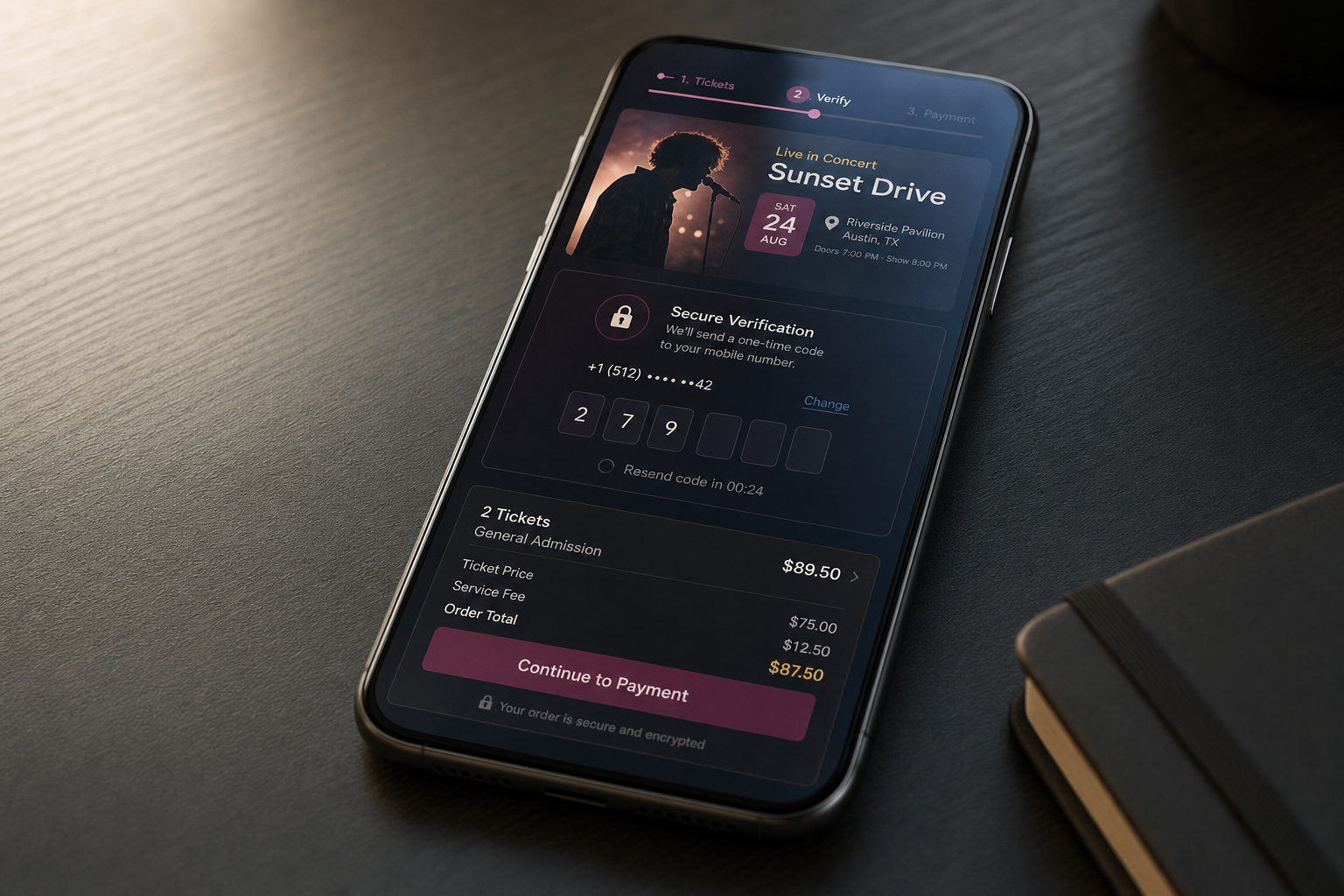 Smartphone displaying a concert ticket purchase screen with secure verification and cost details on a wooden table.