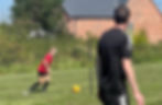 Coach observing female footballer