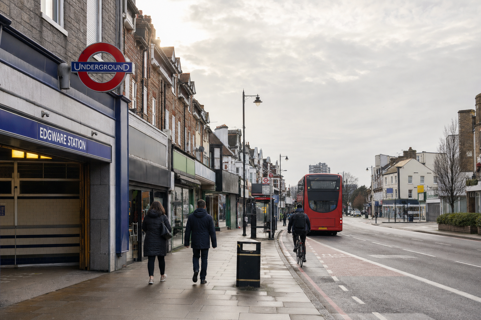 Busy street scene near Edgware Underground Station with pedestrians, a cyclist, and a red double-decker bus.