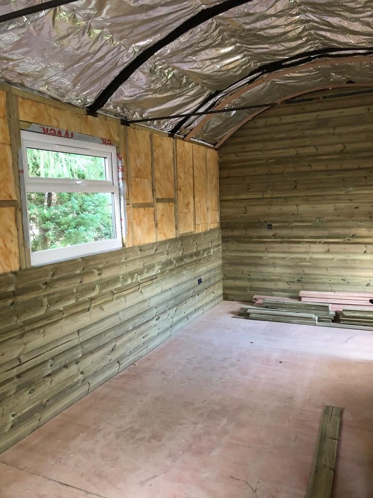 Internal view of a hut showing insulation and timber cladding.