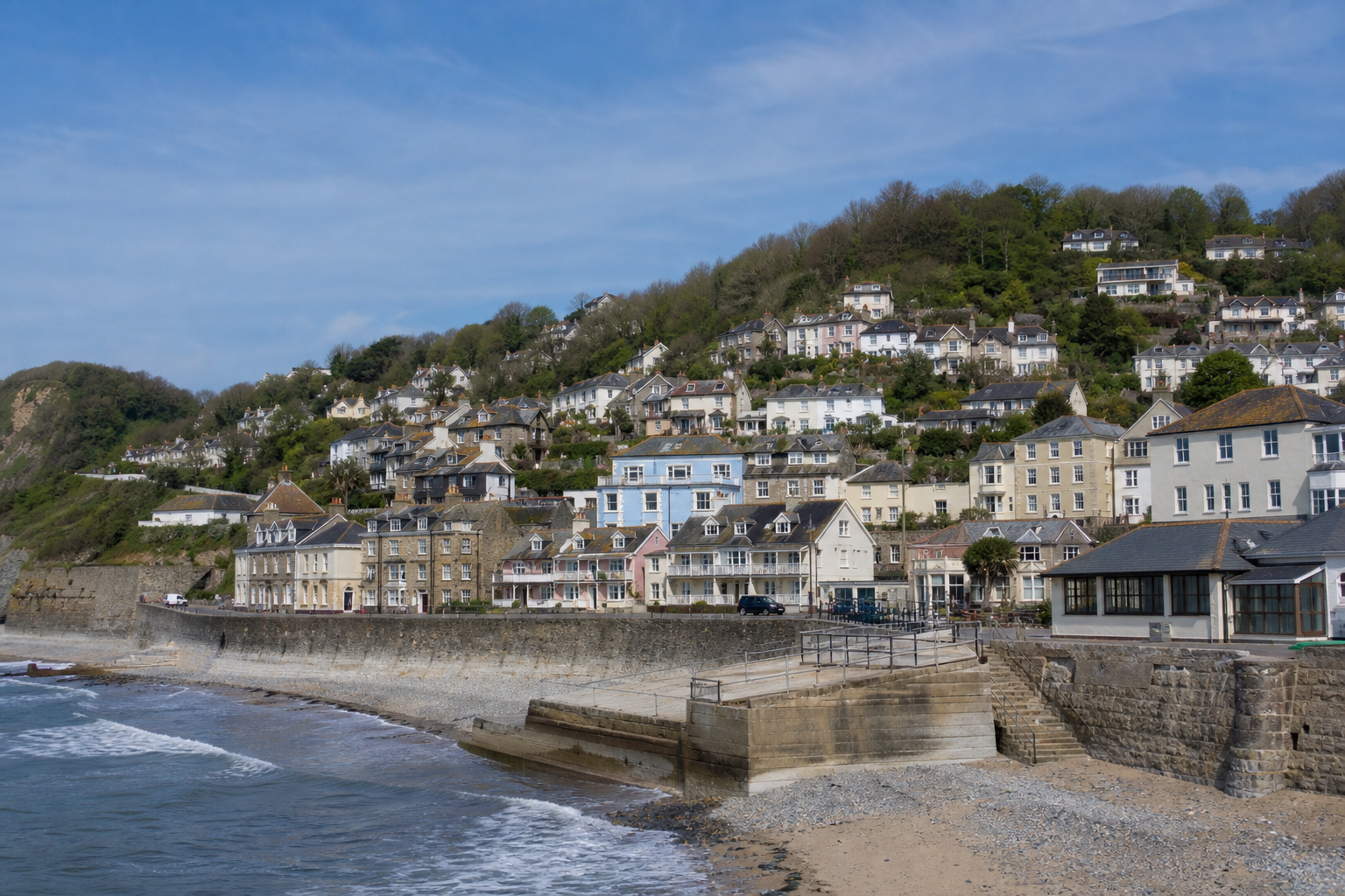 Seaside village with charming houses nestled on a hillside overlooking the beach.