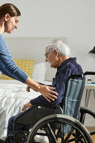 carer helping a man in a wheelchair
