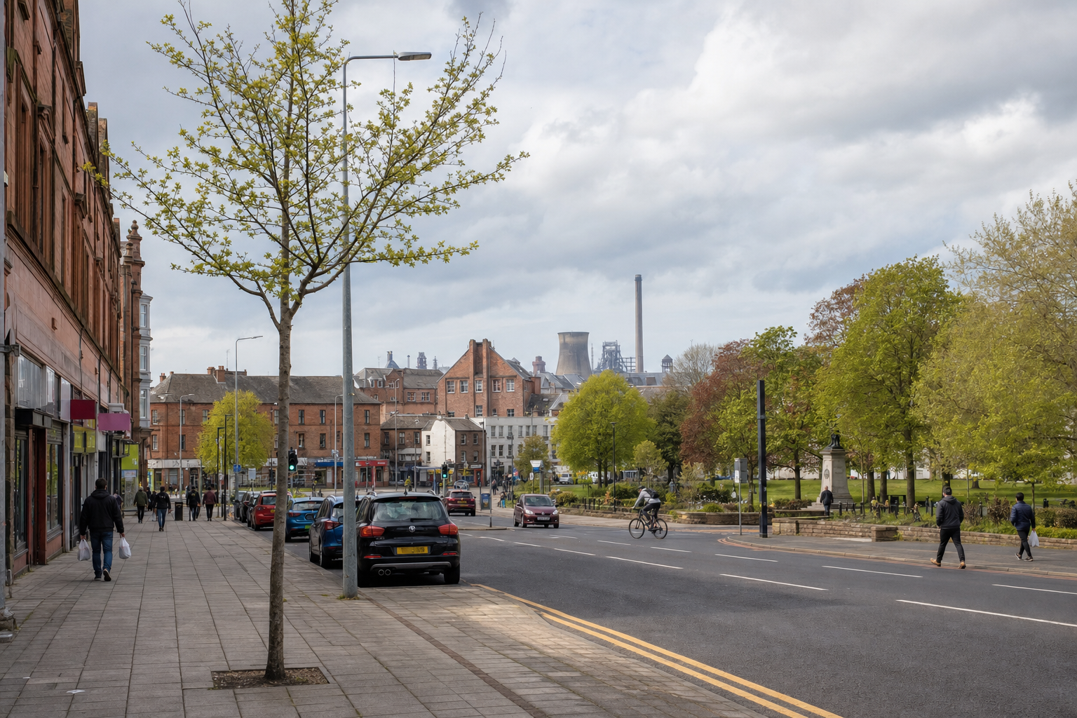 Urban street scene with people walking and cycling, lined with trees and red brick buildings under a cloudy sky.