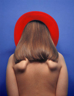 Large digital photograph titled 'Cherub' by fine artist Pernille Holm showing a young girl seen from the back with 'wings' and a red hat