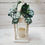 Thumbnail: Lantern adorned with handcrafted sola wood flowers, artificial greenery, and a decorative bow, creating a beautiful tribute to mom. 
