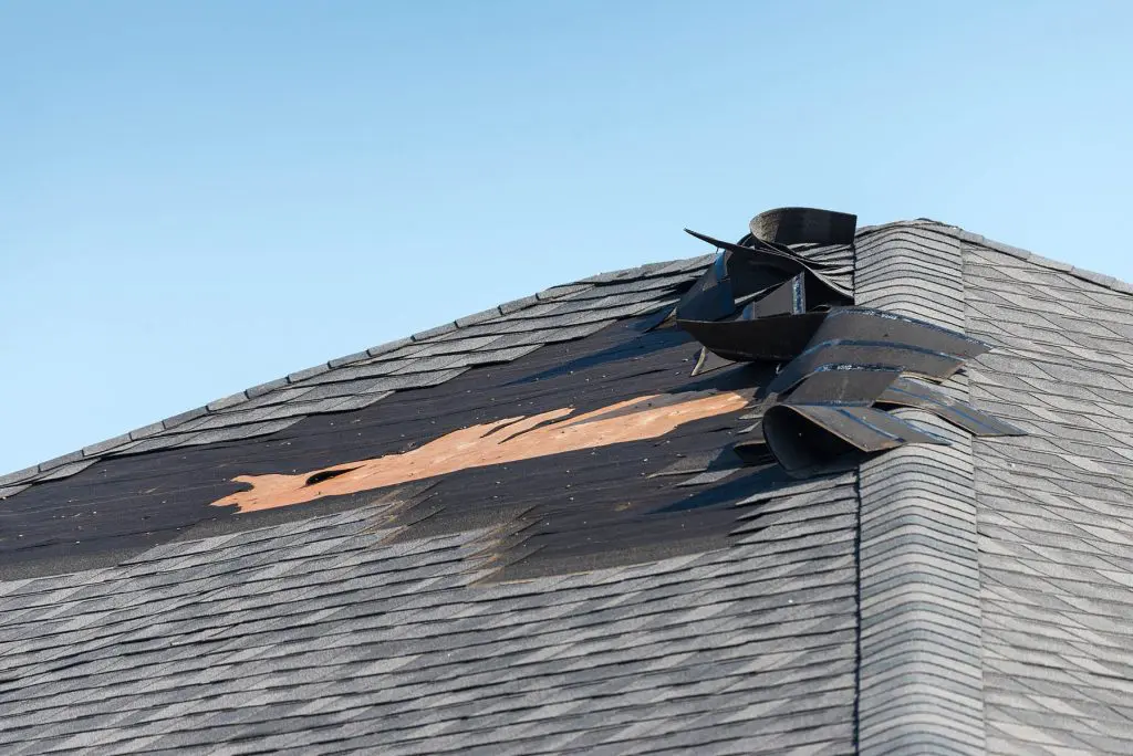 wind damage to a roof in houston after a tornado in cypress and katy