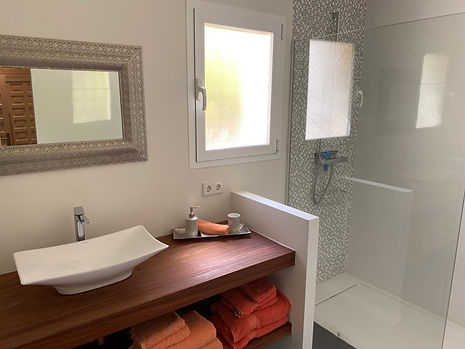 Coral bathroom with shower and nextdoor toilet