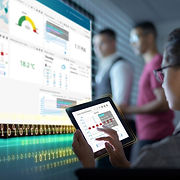 Workers looking at a data dashboard