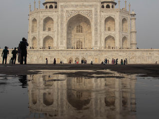 Taj Mahal with its reflection in a puddle of water on the floor