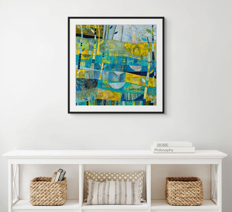 abstract landscape coastal inspired artwork in blue yellow and green framed in a room scene