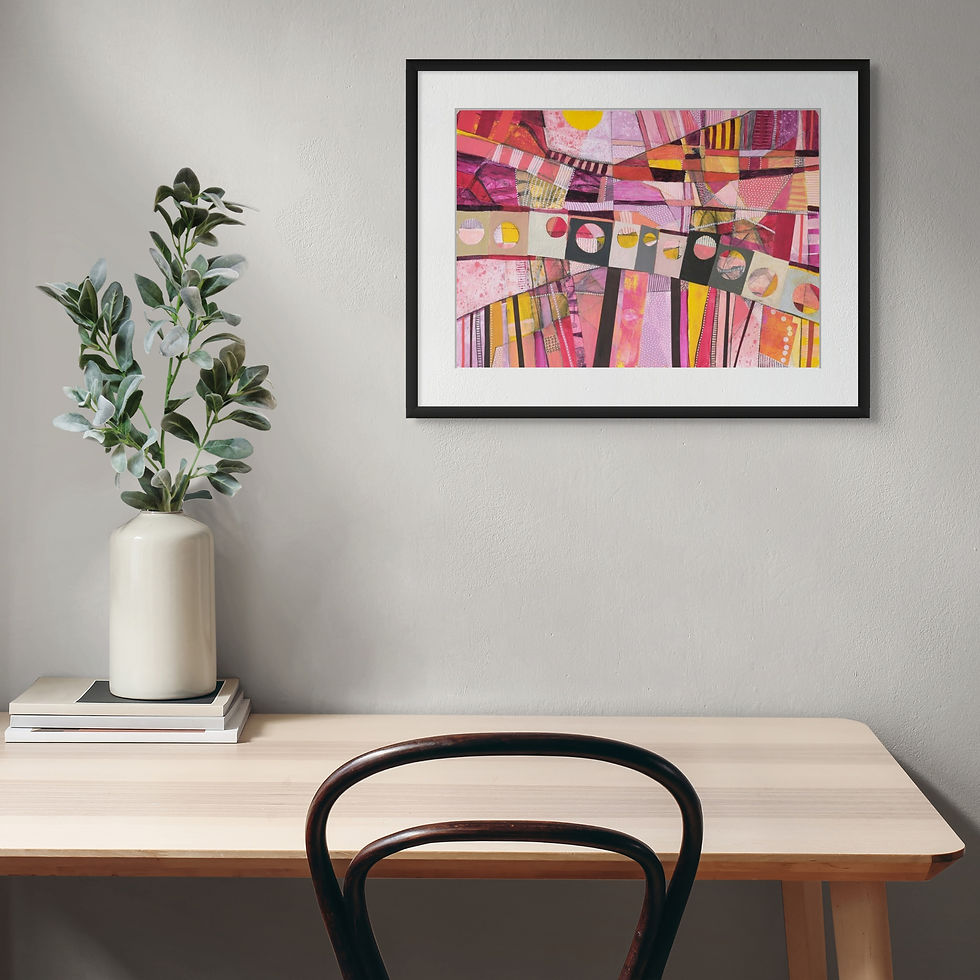 A desk with a potted plant and books, beneath an abstract artwork in bright pinks and yellows on a gray wall. Minimalist and serene.