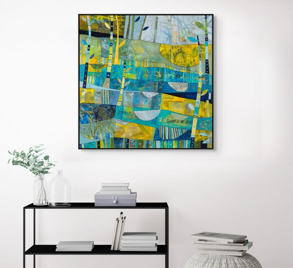abstract landscape coastal inspired artwork in blue yellow and green framed in a room scene