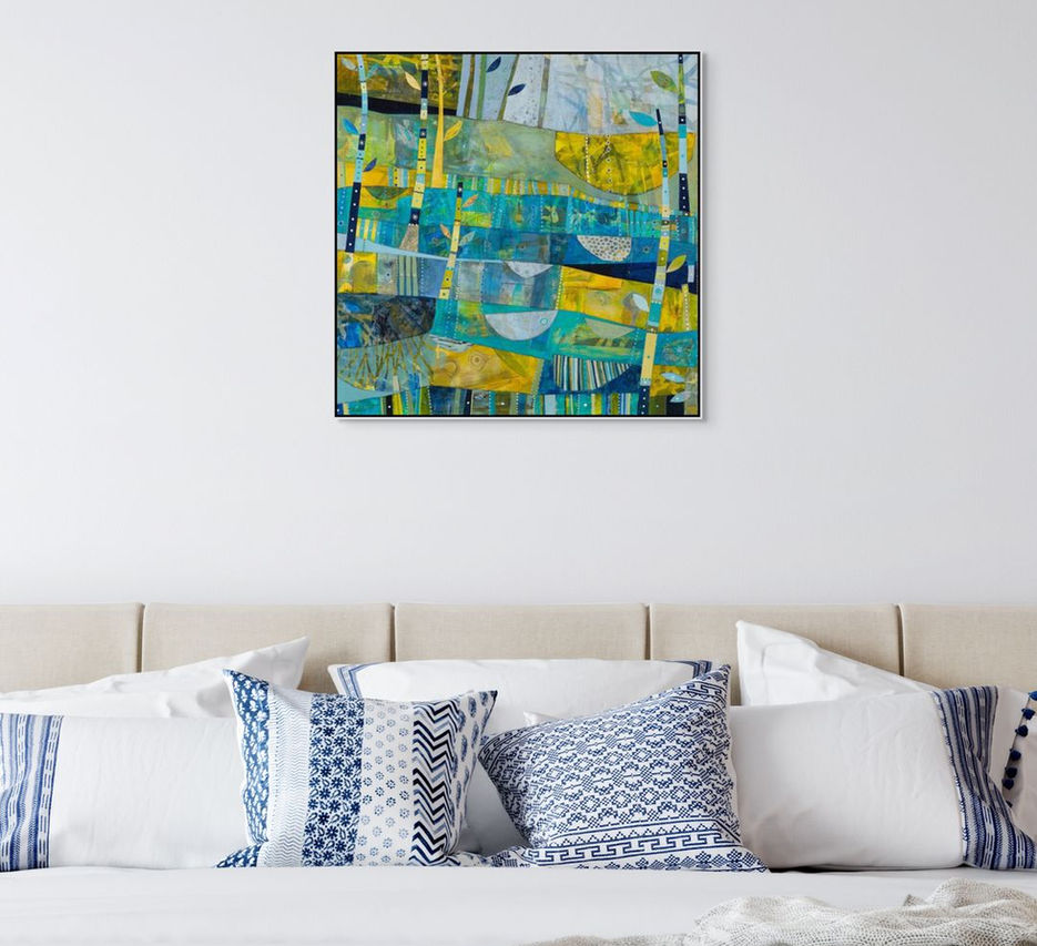abstract landscape coastal inspired artwork in blue yellow and green framed in a room scene