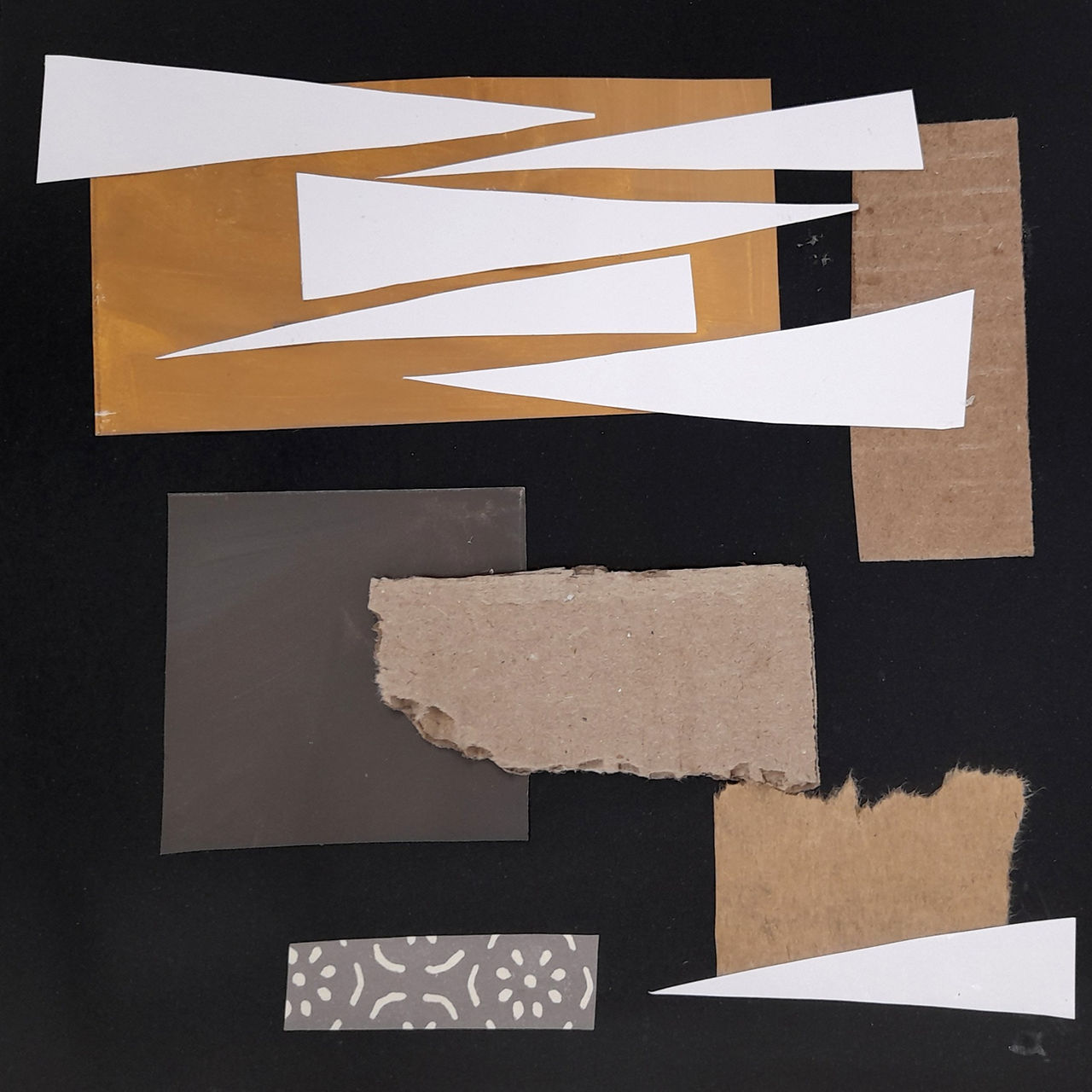 torn and cut paper collage in white and neutral on black background