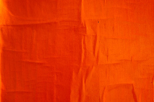 close up image of red paint texture on a canvas