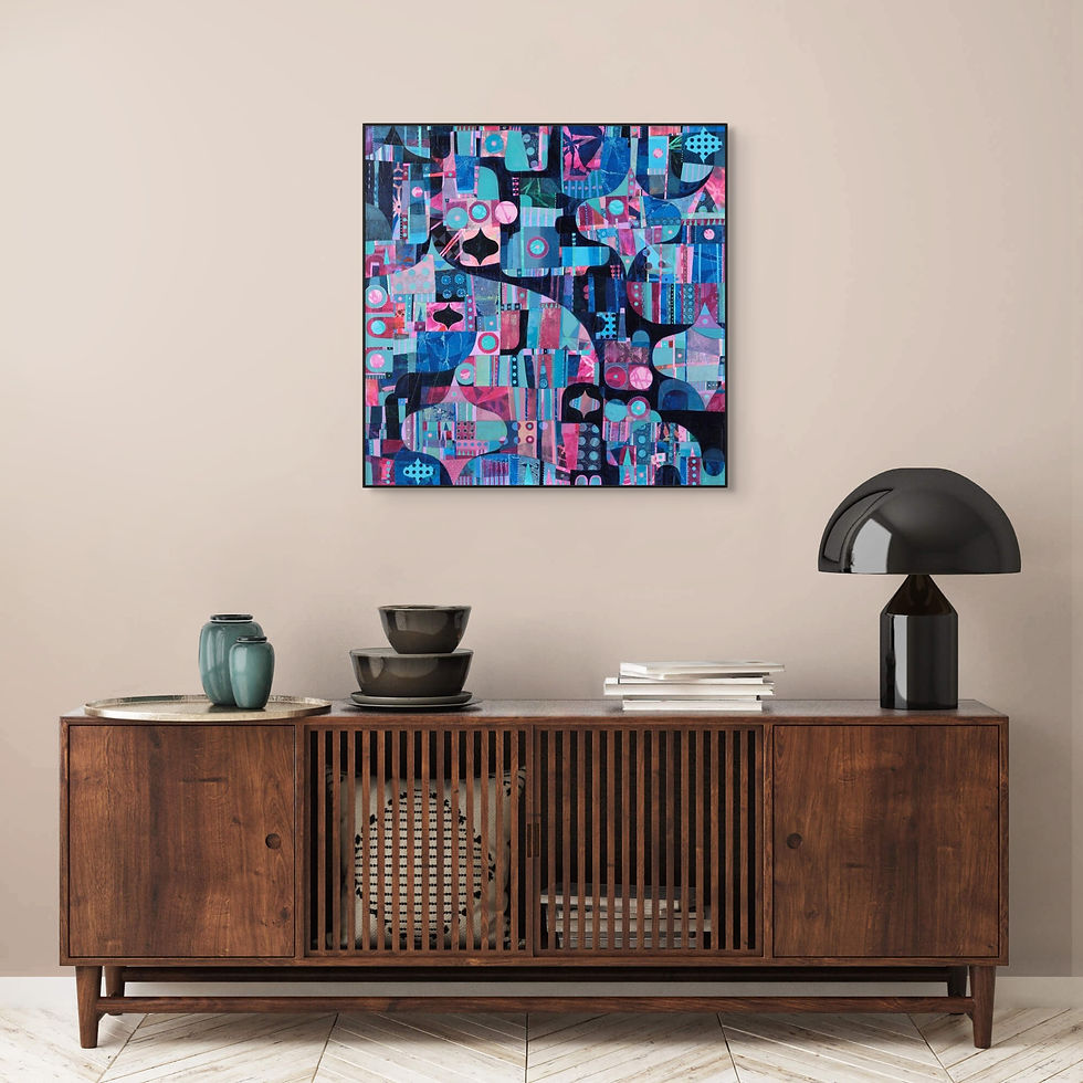 Abstract blue and pink painting on wall above a wooden console with gray lamp, bowls, and green vase in a modern room setting.