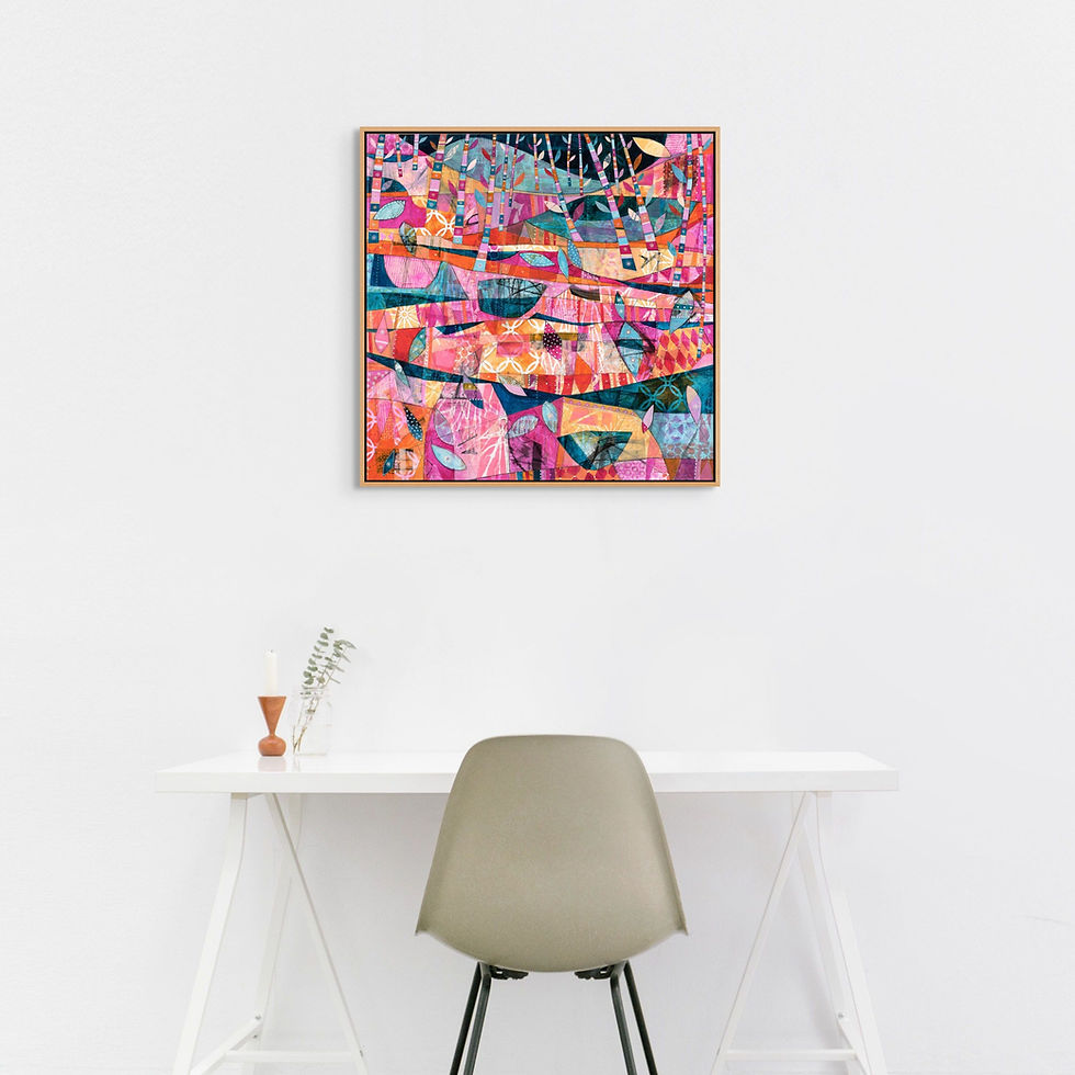 Colorful abstract painting on a white wall above a minimalist desk with a gray chair. The vivid artwork features geometric patterns.