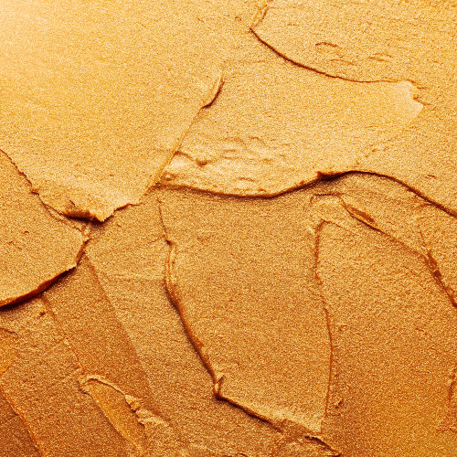 thick golden coloured acrylic paint abstract crop view