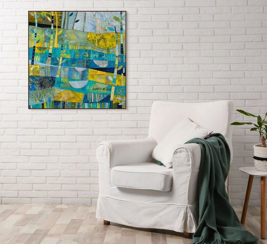 abstract landscape coastal inspired artwork in blue yellow and green framed in a room scene