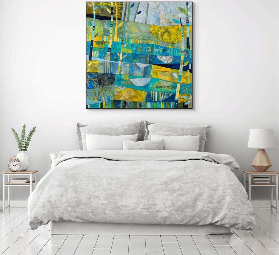 abstract landscape coastal inspired artwork in blue yellow and green framed in a room scene