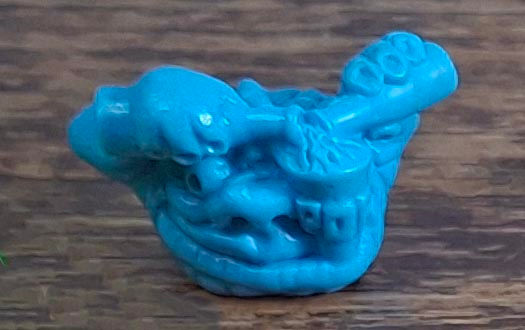 A blue plastic collectable boglin creature