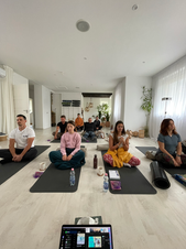 Group breathwork session in a bright indoor space, deepening focus, body awareness and stress resilience