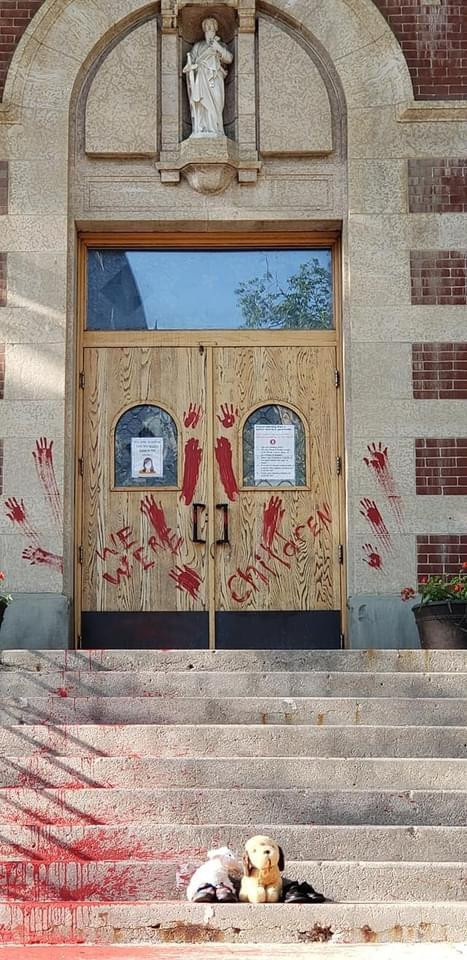 (Cred: D. Heimbecker) The doors of St. Paul's Co-Cathedral were painted in protest after the discovery of 715 (sic) unmarked graves near the former Marieval Residential School on the Cowessess First Nation on Thursday.