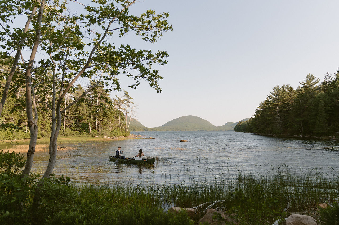 couple canoeing on eagle lake in acadia on elopement day