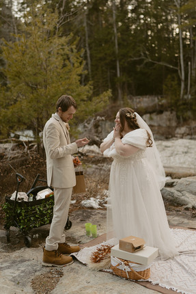 Couple enjoying a picnic on white mountains elopement day along the kancamagus highway after loon mountain elopement