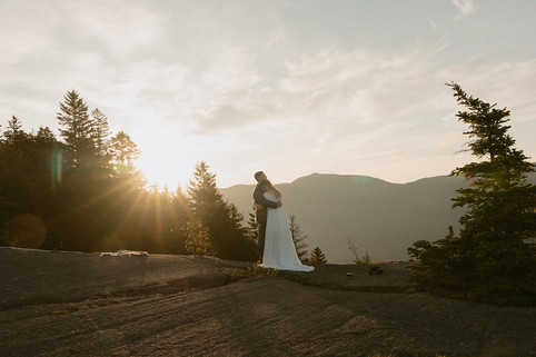 Pinkham notch sunrise elopement couple enjoying view of mountains from summit on elopement day