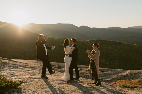 couple during ceremony for waterville valley elopement at sunrise