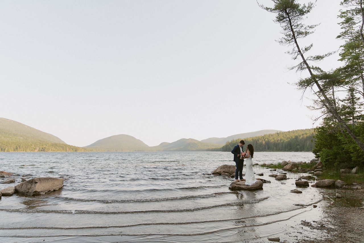 couple canoeing on eagle lake in acadia on elopement day