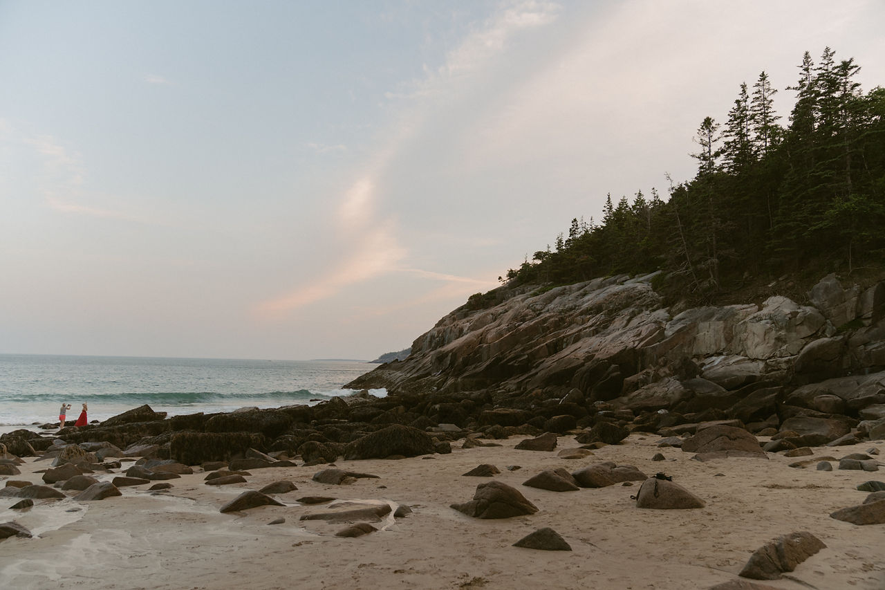 couple enjoying luxury picnic on sand beach after sand beach wedding in acadia