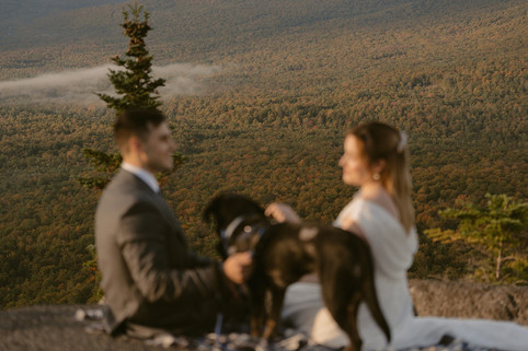Pinkham notch sunrise elopement couple enjoying view of mountains from summit on elopement day