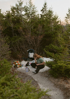 White Mountains Micro Wedding with family on a mountain top at sunrise in the fall bride getting ready on mountain top
