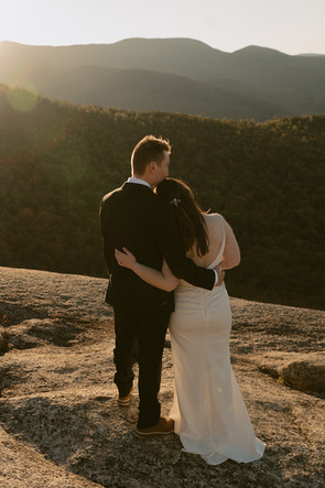Couple exploring after ceremony on mountain top for sunrise elopement in waterville valley