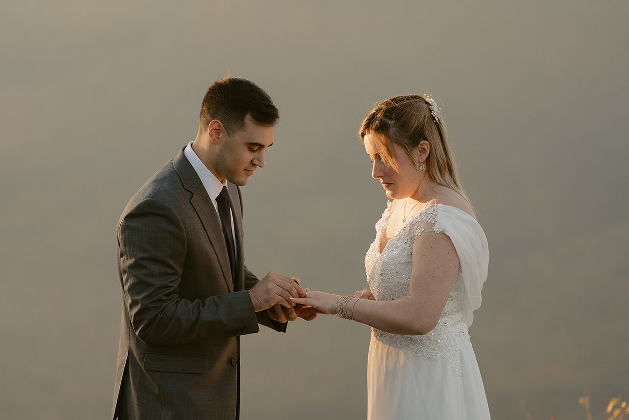 Pinkham notch sunrise elopement couple enjoying view of mountains from summit on elopement day