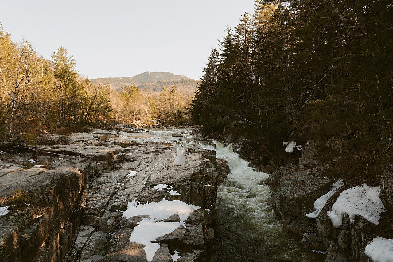 Couple exploring rocky gorge for white mountains elopement day