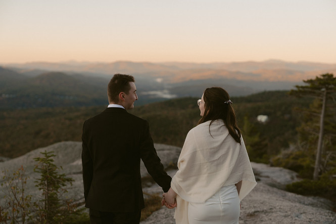 couple enjoying the sunrise for sunrise elopement in the white mountains in waterville valley