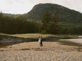 A couple on their elopement day in Acadia for spring elopement dancing on Sand Beach