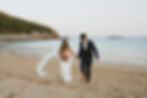 acadia national park elopement couple running on sand beach.