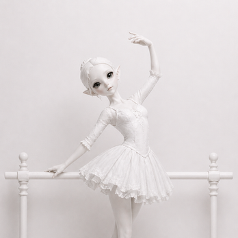 A porcelain white kawaii resin ballerina sculpture in a lace tutu at a barre on pointe, part of the Between Worlds series by YuzuYume.